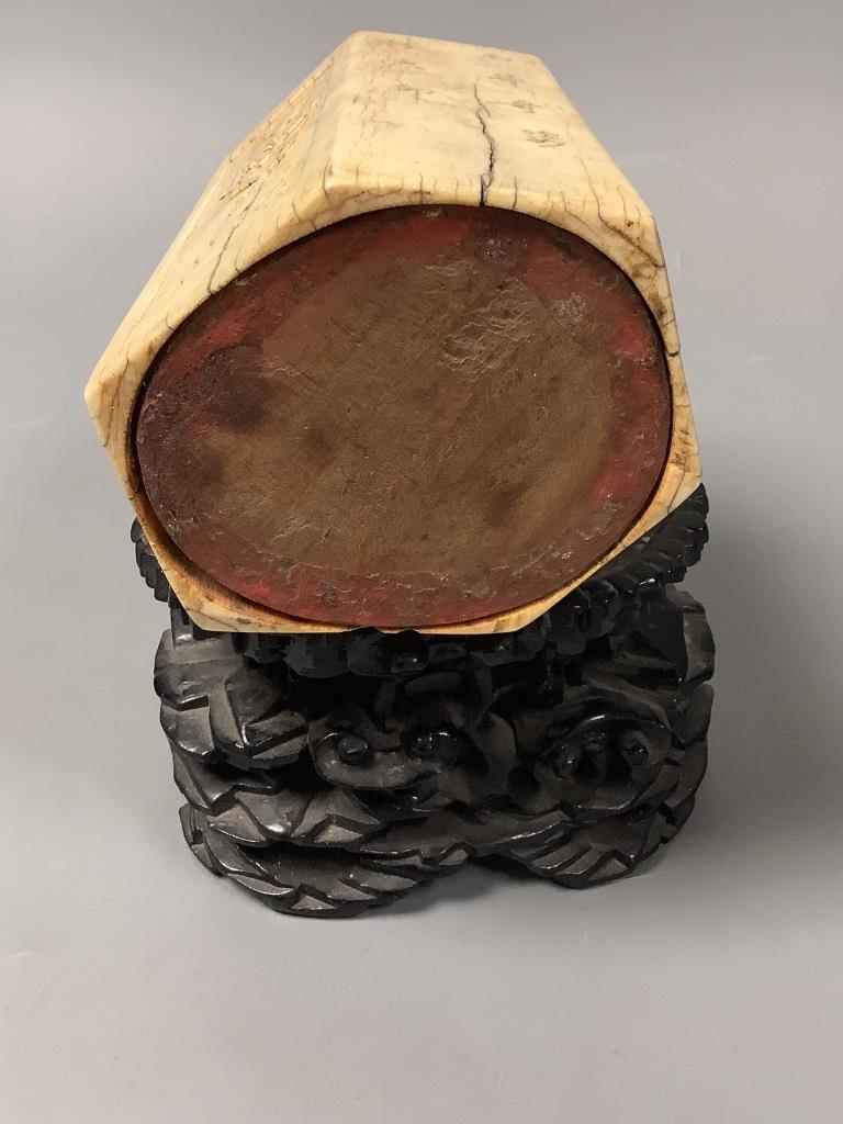 A Chinese inscribed ivory hexagonal brushpot, 17th/18th century, 12.2cm high, replacement wood base panel, age cracks, with associated hardwood stand